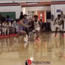 a basketball game is being played on a court with a productions logo in the corner
