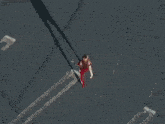 a woman walking in a parking lot in front of a store called jcpenney