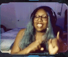 a woman wearing glasses and headphones is giving the middle finger