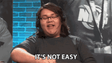 a man wearing a headset says it 's not easy