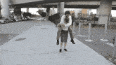 Woman Lifts And Carries Man Absurd Man Woman Gif GIF - Woman Lifts And Carries Man Absurd Man Woman Gif GIFs