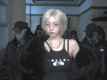 a woman wearing a black valley tank top