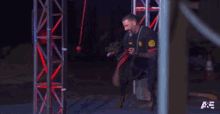 a man is sitting on a stool with a dog and playing with it .