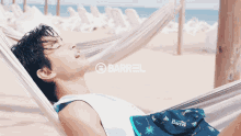 a man laying in a hammock with the word barrel on the bottom right