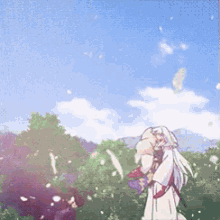 a woman in a white dress is standing in a field of flowers