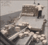 a man is loading boxes onto a truck with a 4gifs.com watermark