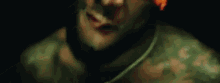 a close up of a man 's face in a dark room .