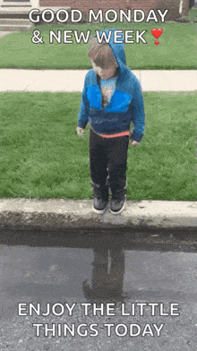 a young boy is jumping into a puddle of water .