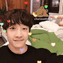 a young man taking a selfie with hearts around his face and the name chaneadita written on the bottom