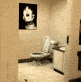 a bathroom with a toilet and a picture of a man on the wall