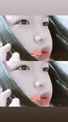 a close up of a girl 's face with a heart on it