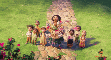 a group of children are standing around a woman holding a tray of food