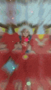 a blurry picture of a child wearing a red dress