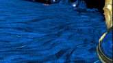 a computer generated image of a blue and gold sculpture