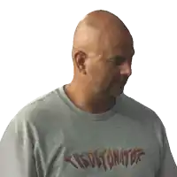 a bald man is wearing a gray shirt that says the detonator
