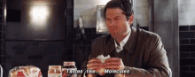 a man is eating a sandwich and saying tastes like molecules .