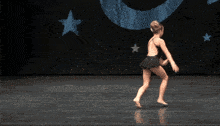 a girl is doing a handstand in front of a star