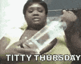 a woman is holding a bottle of water and the words titty thursday are written on the bottom of the image .