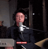 a man wearing headphones talks into a microphone