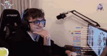a man wearing headphones and glasses sits in front of a gtracing gaming chair