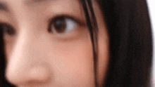 a close up of a woman 's face with her eyes open .