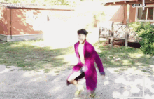 a man in a purple robe is standing in front of a house with the hashtag funny_a