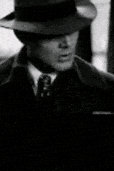 a black and white photo of a man wearing a hat and tie with the word if in the lower right corner