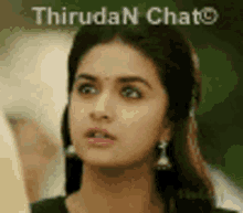 a close up of a woman 's face with the words thiruda n chat on the bottom .