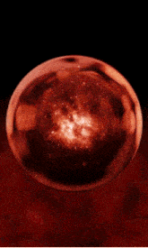 a red sphere with a black background and stars