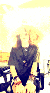 a blurry picture of a woman sitting in a chair with the letter m on her shirt