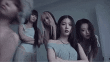 a group of young women are standing next to each other in a room .