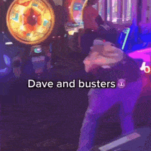 a person is playing a game with the words dave and busters on the bottom