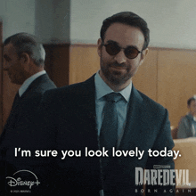 a man in a suit and tie says " i 'm sure you look lovely today " on a daredevil poster