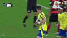 a soccer player with the number 7 on his jersey is holding a ball