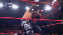a man in a wrestling ring with a glove that says ' smackdown ' on it