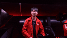 a man in a red jacket is sitting in a chair that says secret lab