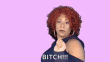 a woman with red curly hair is making a funny face and saying `` bitch '' .