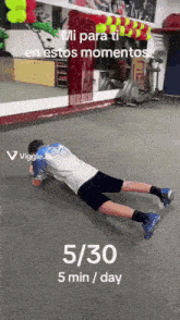 a man is doing a plank exercise in a gym with the time of 5/30