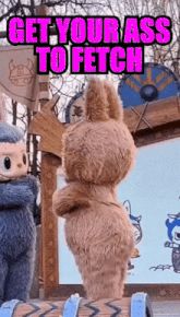 a stuffed animal with the words get your ass to fetch written on it