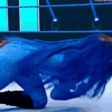 a woman in a blue outfit is laying on the ground