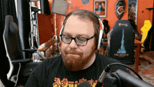 a man with a beard wearing headphones and a final fantasy t-shirt