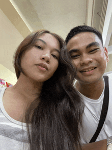 a man and a woman are posing for a photo together
