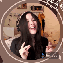 a woman wearing headphones is smiling in a circle with invideo written on the bottom