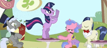 a group of ponies are standing around a table with a book that says ehb on it