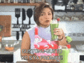 a woman in an apron is holding a green smoothie in her hand .