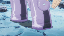 a person is holding a purple object with a small hole in the middle