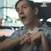 a man in a wheelchair with the words " you 're my hero " behind him