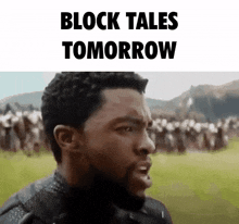 a man with a beard is standing in front of a crowd with the words `` block tales tomorrow '' .