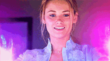 a close up of a woman 's face with purple lights behind her