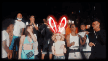 a group of people are posing for a photo with a red light that says a2